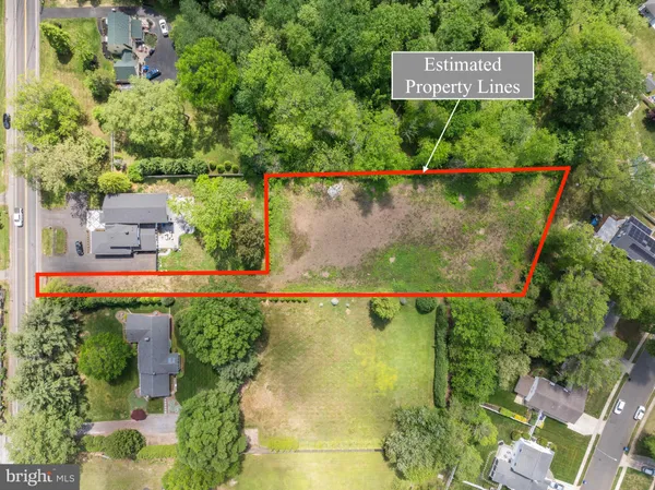 an aerial view of a house with a yard and black garden