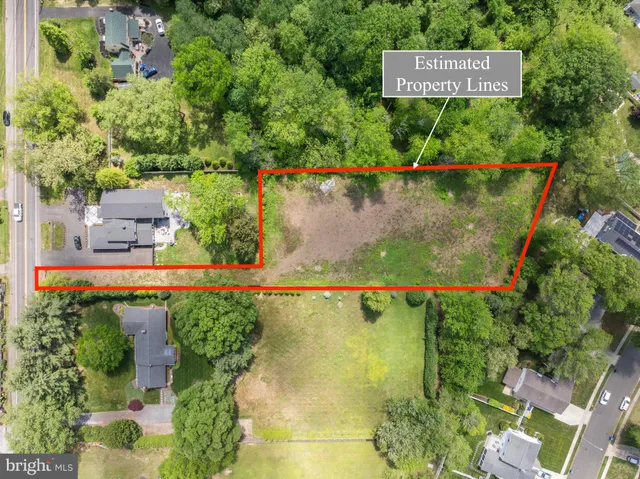 an aerial view of a house with a yard and black garden