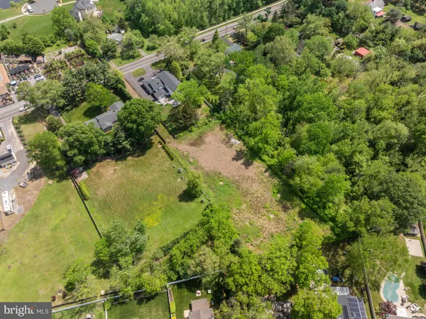 an aerial view of a residential houses with yard