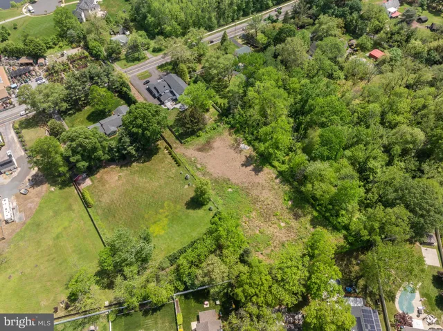 an aerial view of a residential houses with yard