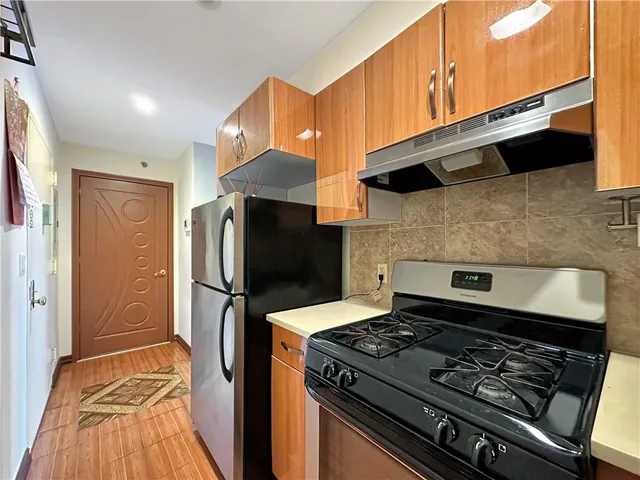 a kitchen with stainless steel appliances granite countertop a stove and a microwave