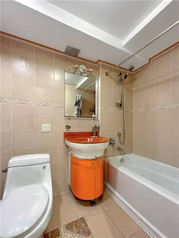 a bathroom with a toilet a sink and bathtub