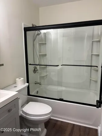 a bathroom with a toilet a sink and a shower