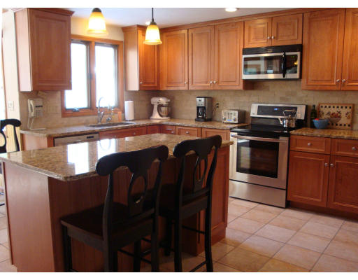 102 Barnett Road Sutton, MA 01590 - Photo 13 of 30 a kitchen with stainless steel appliances granite countertop a stove a sink a microwave and a refrigerator