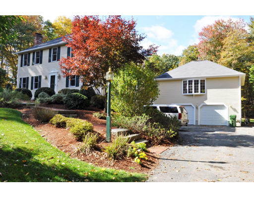 102 Barnett Road Sutton, MA 01590 - Photo 4 of 30 a front view of a house with a yard and outdoor seating