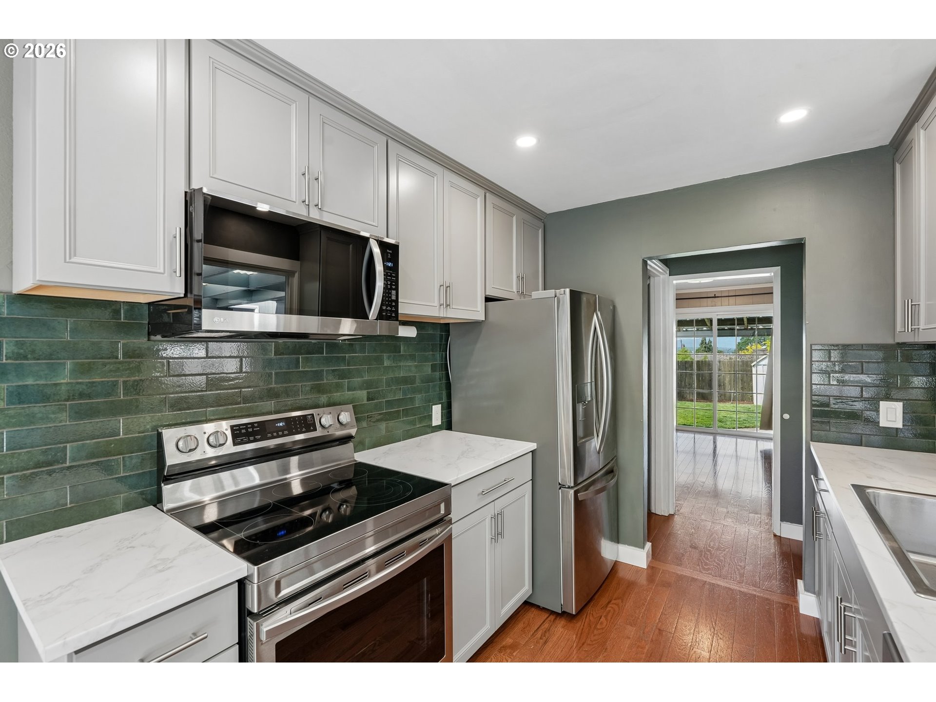 4204 Fir Street Vancouver, WA 98660 - Photo 11 of 37 a kitchen with stainless steel appliances a stove a microwave a sink and cabinets