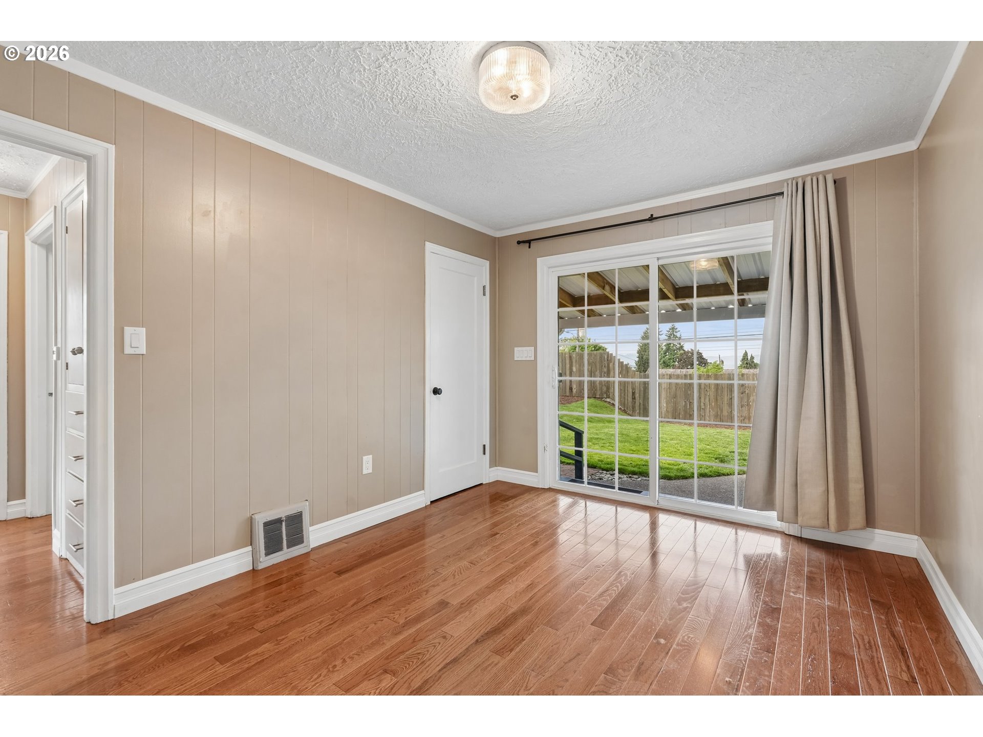 4204 Fir Street Vancouver, WA 98660 - Photo 13 of 37 a view of an empty room with wooden floor and a window