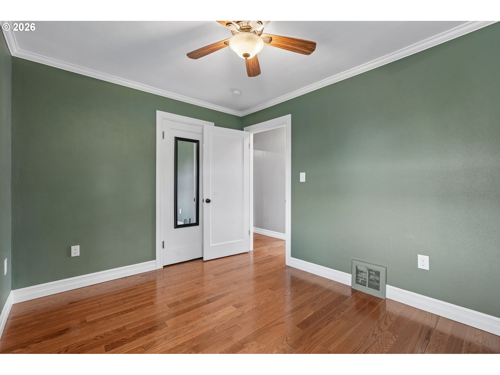4204 Fir Street Vancouver, WA 98660 - Photo 19 of 37 a view of an empty room with window and wooden floor
