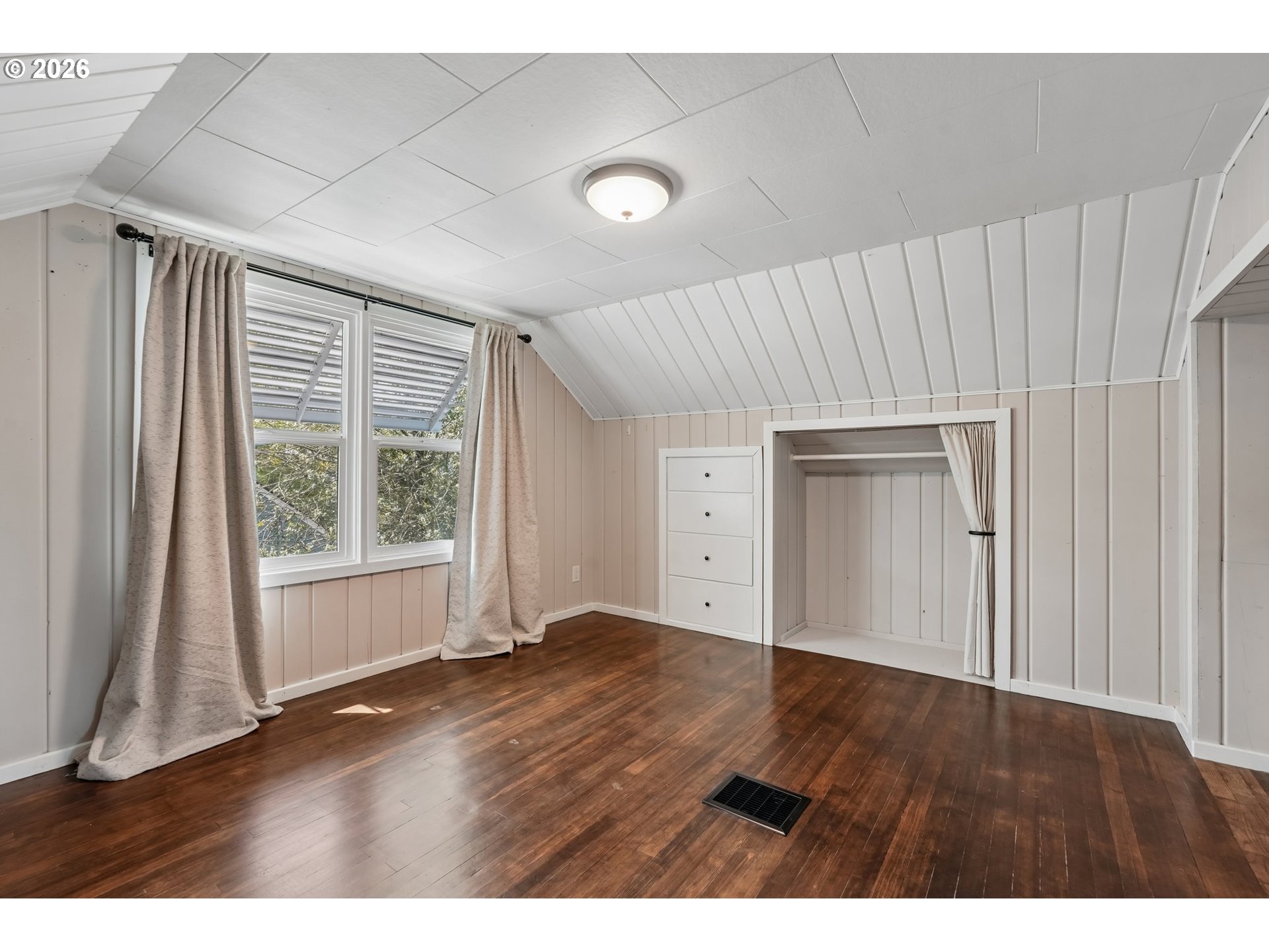 4204 Fir Street Vancouver, WA 98660 - Photo 22 of 37 a view of an empty room with a window and wooden floor