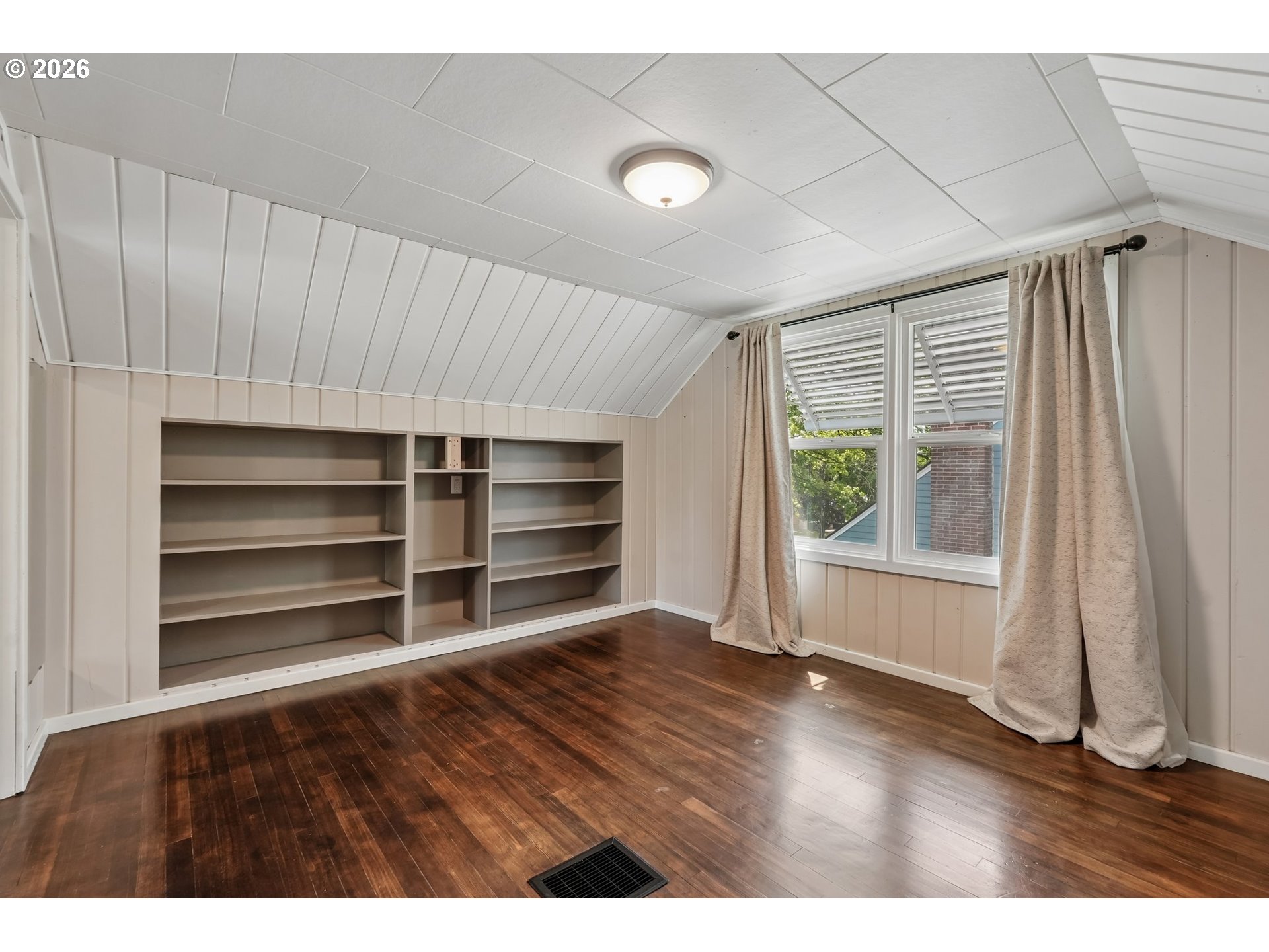 4204 Fir Street Vancouver, WA 98660 - Photo 23 of 37 a view of an empty room with a window and wooden floor