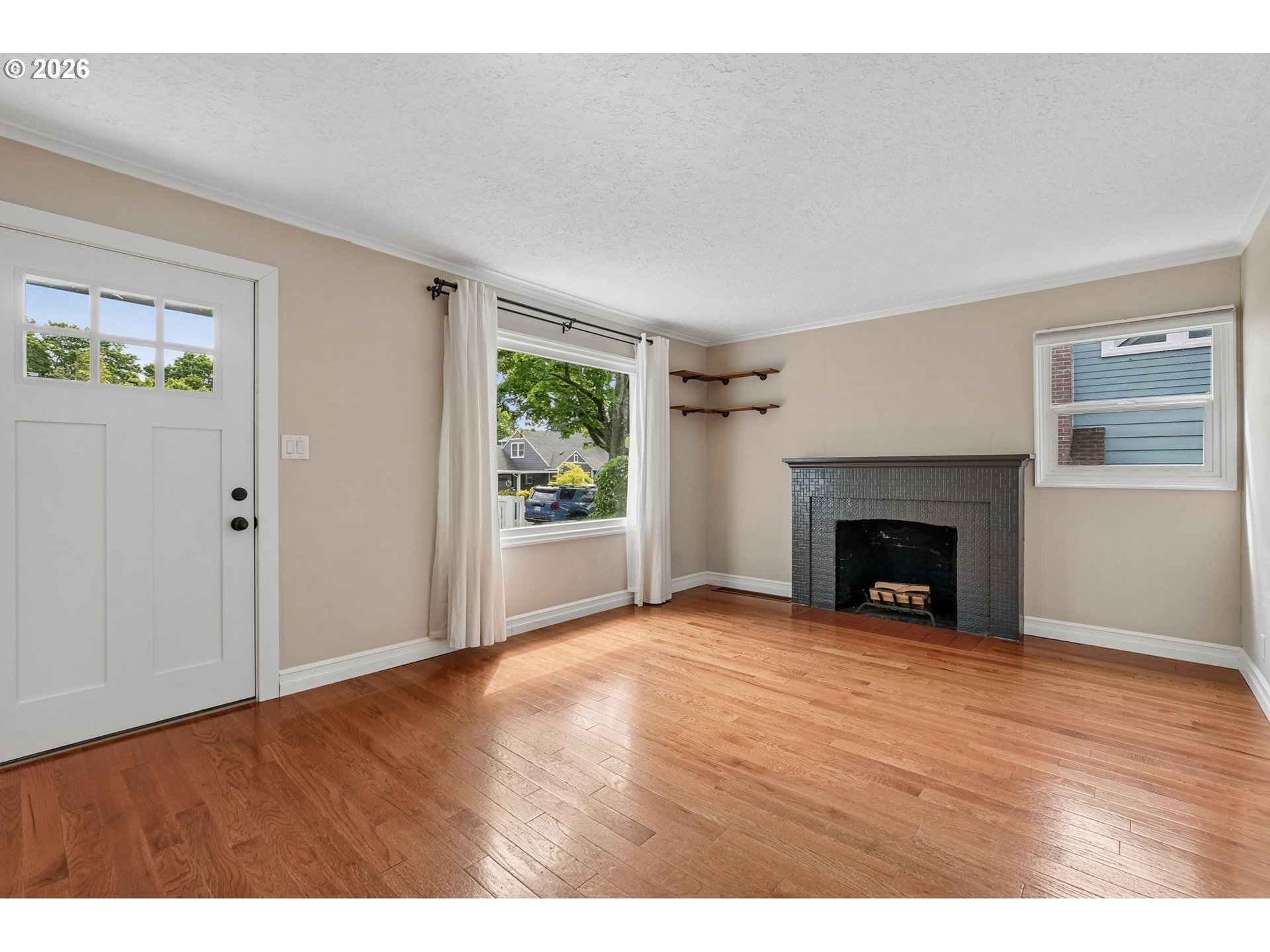 4204 Fir Street Vancouver, WA 98660 - Photo 4 of 37 a view of an empty room with wooden floor and a window