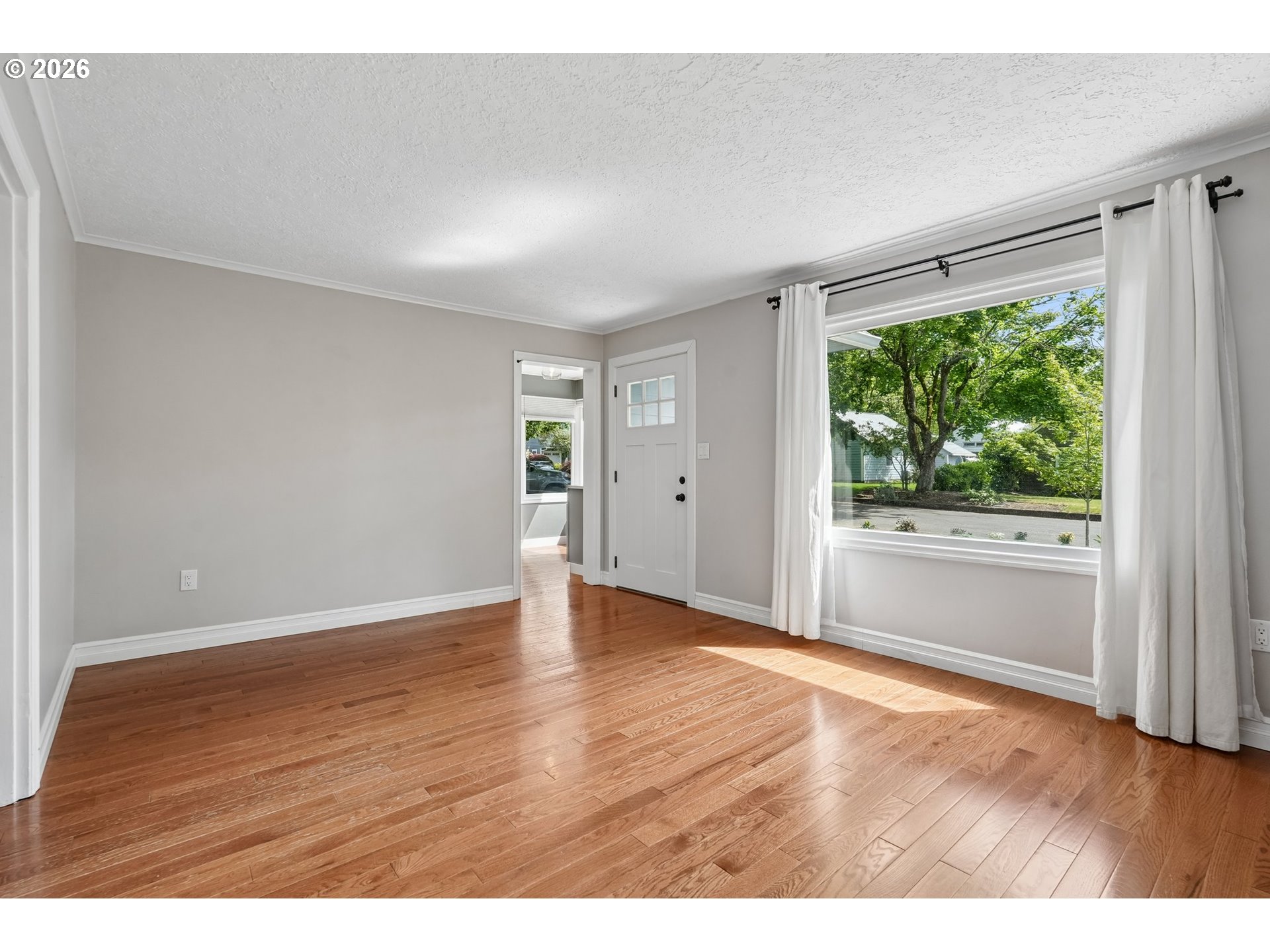 4204 Fir Street Vancouver, WA 98660 - Photo 7 of 37 a view of an empty room with wooden floor and a window