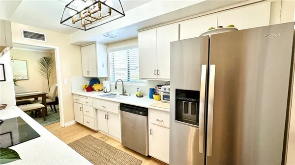 a kitchen with stainless steel appliances a refrigerator sink and cabinets