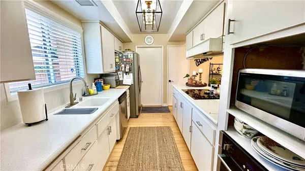 a kitchen with stainless steel appliances a stove a sink and a microwave