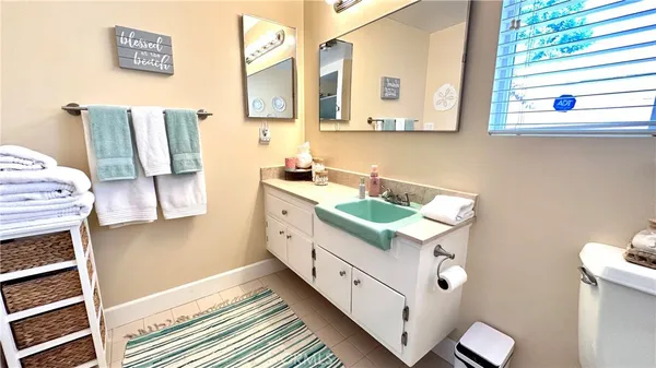 a bathroom with a double vanity sink mirror and toilet