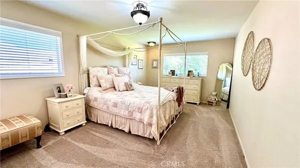 a bedroom with a bed mirror and window