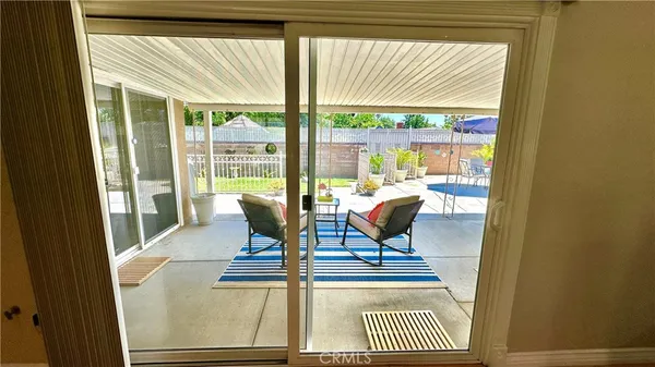 a view of a dining room with furniture wooden floor and a potted plant