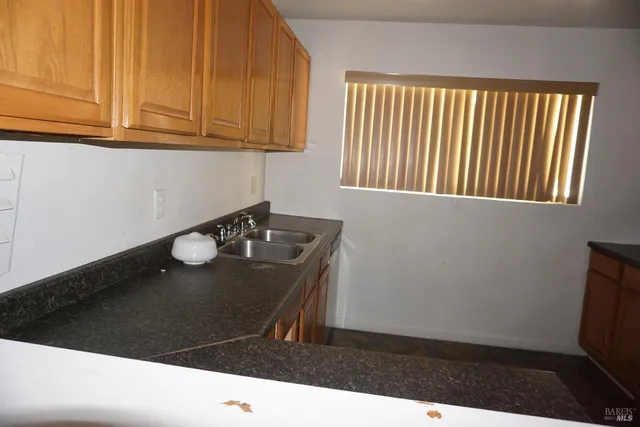 a kitchen with stainless steel appliances granite countertop a stove a microwave and a refrigerator
