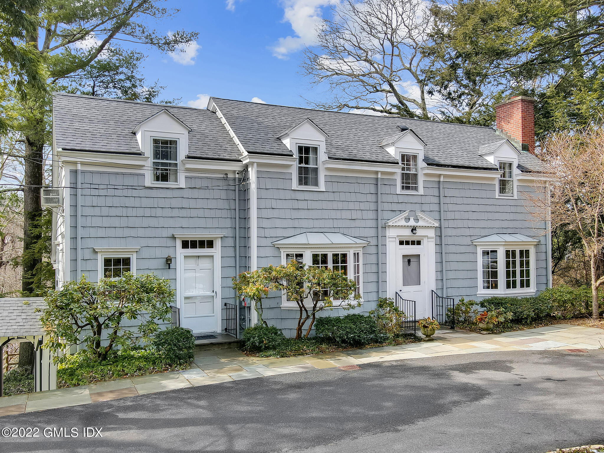 a front view of a house with a garden