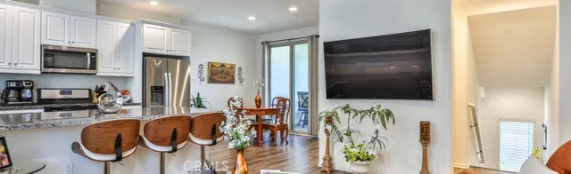 a dining room with furniture a flat screen tv and a fireplace