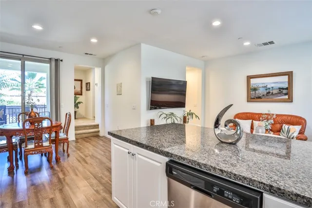 a kitchen with stainless steel appliances granite countertop a stove and a wooden cabinets