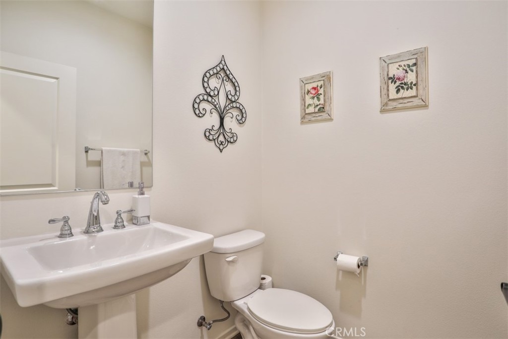 877 Orchid Way Azusa, CA 91702 - Photo 15 of 40 a bathroom with a sink mirror and a toilet
