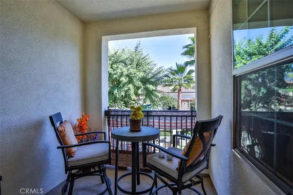 a view of a chairs and table in patio