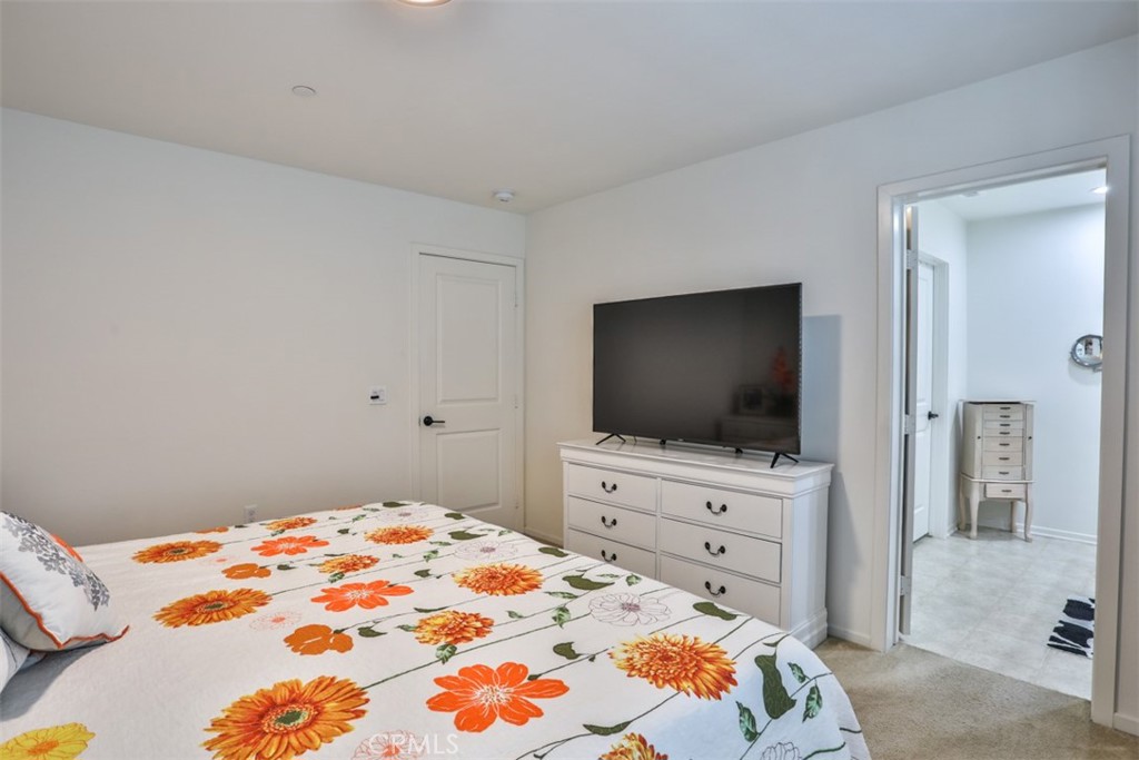 877 Orchid Way Azusa, CA 91702 - Photo 20 of 40 a bedroom with a bed and a flat screen tv