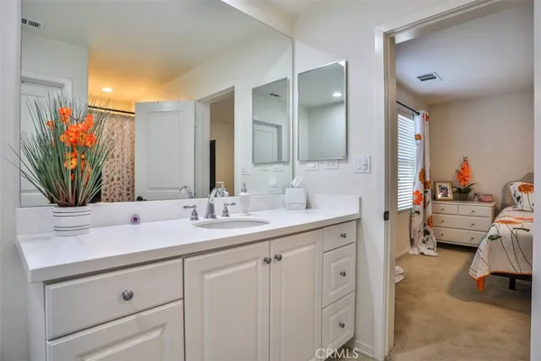 a bathroom with a sink double vanity and mirror