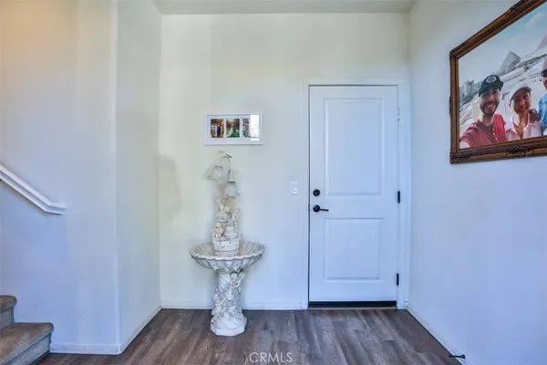 a room with wooden floor and a painting on the wall