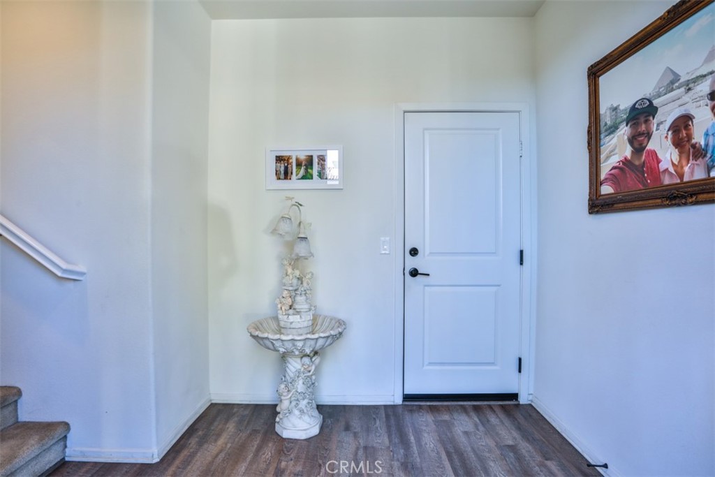 877 Orchid Way Azusa, CA 91702 - Photo 7 of 40 a room with wooden floor and a painting on the wall