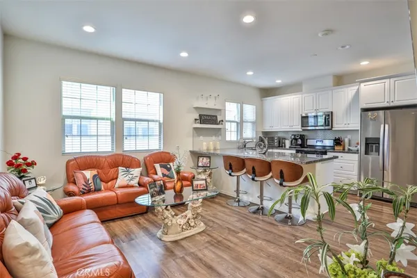 a living room kitchen with furniture and a large window