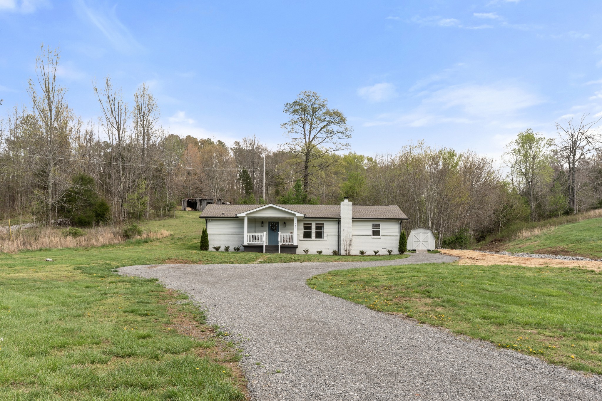 2957 Distillery Road Greenbrier, TN 37073 - Photo 3 of 41 a view of a house with a big yard and large trees