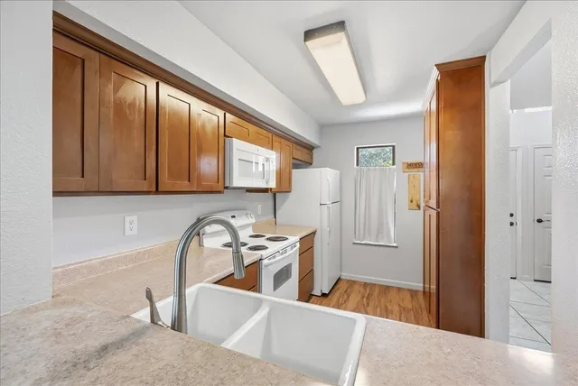 a kitchen with stainless steel appliances granite countertop a refrigerator and a sink