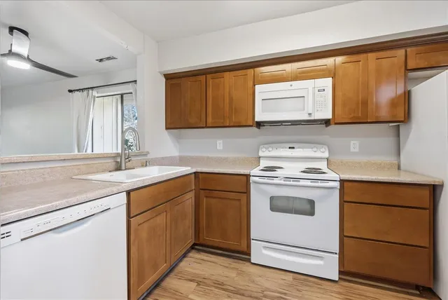a kitchen with a stove sink and a microwave
