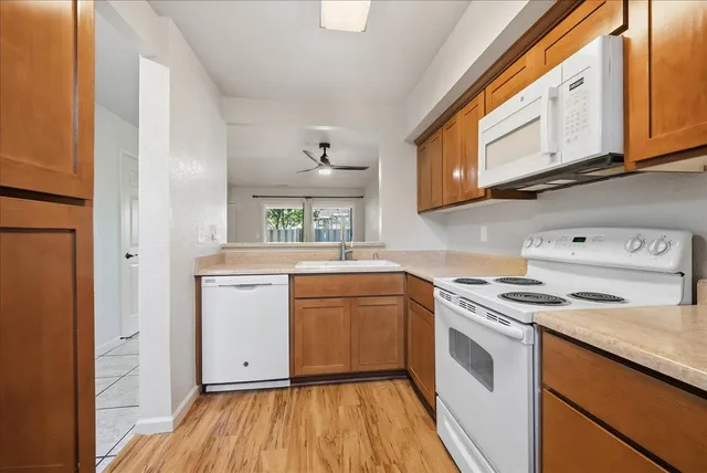 a kitchen with stainless steel appliances granite countertop wooden cabinets and a stove top oven
