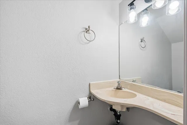a bathroom with a sink and a mirror