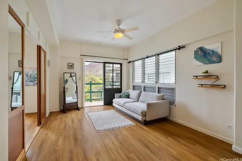 a living room with furniture and a floor to ceiling window