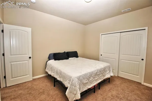 a bedroom with a bed and cabinet