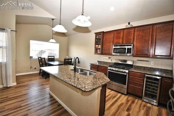 a kitchen with stainless steel appliances granite countertop a stove and a sink