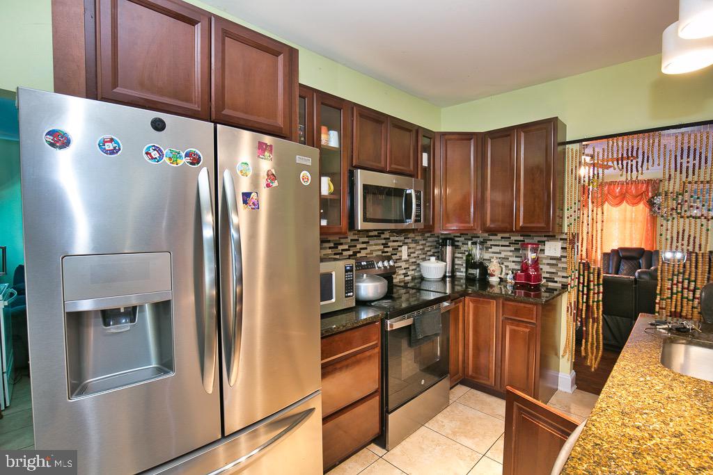 430 Priscilla Street Salisbury, MD 21804 - Photo 34 of 60 a kitchen with stainless steel appliances granite countertop a refrigerator stove a sink dishwasher and microwave