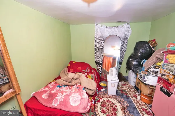 a bedroom with a bed and a painting on the wall