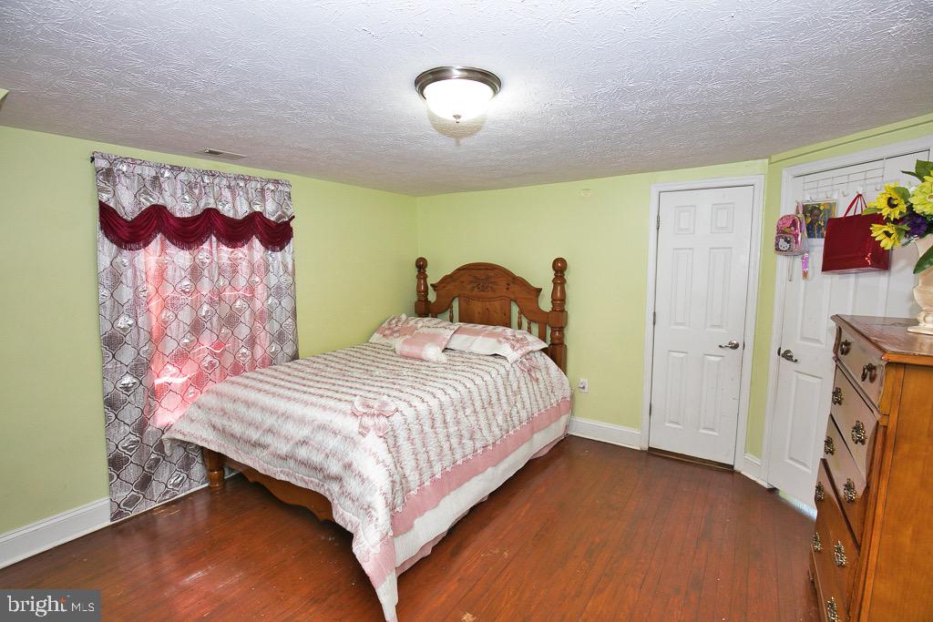 430 Priscilla Street Salisbury, MD 21804 - Photo 56 of 60 a bedroom with a bed and a painting on the wall