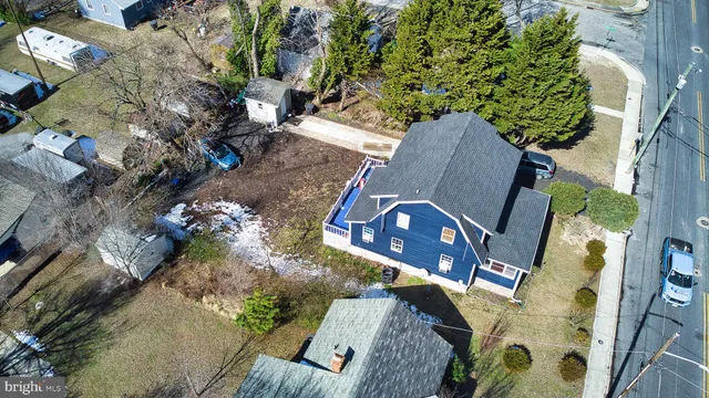 an aerial view of a house with garden space and sitting area