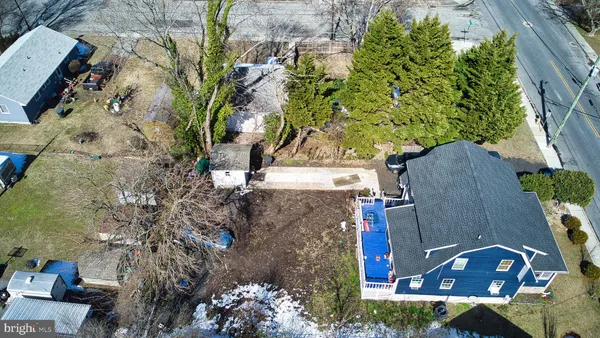 an aerial view of a house with a yard and garden