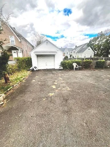 a view of a house with a yard and garage