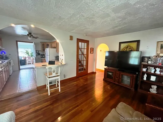 a living room with furniture flat screen tv and wooden floor