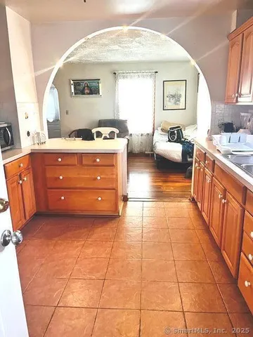 a spacious bathroom with a mirror and a sink