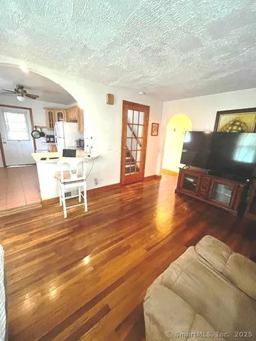 a living room with furniture and wooden floor