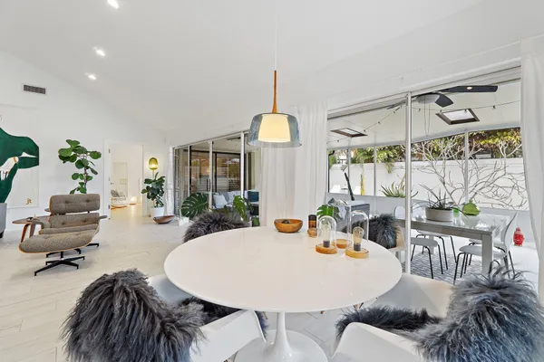 a living room with furniture and floor to ceiling windows